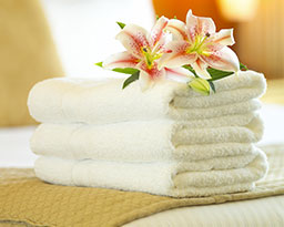 Folded towels with flowers on top.